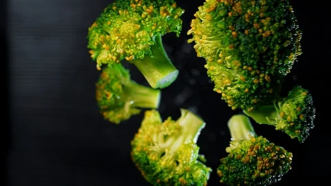 Juicy green broccoli hover in the air in super slow motion. Macro Stock Footage 109155612