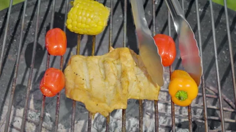 Juicy Grilled Chicken With Char Marks Alongside Sweet Corn And Colorful Peppers Stock Footage 325840670
