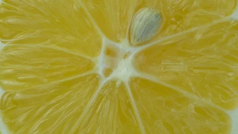 Juicy half of lemon spins closeup Stock Footage 121522499