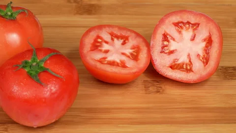 Juicy Halved Fresh Red Tomatoes on Wooden Chopping Board Stock Footage 342756231