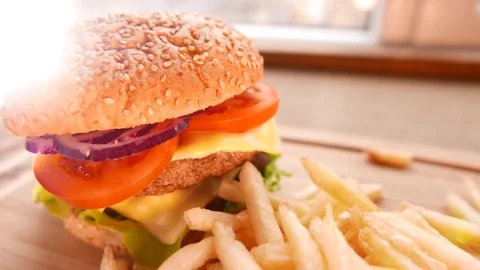 Juicy hamburger with fried potatoes Stock Footage 74170761