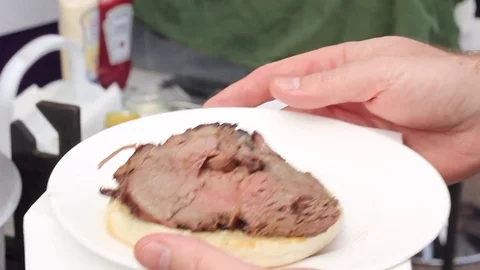 Juicy joint of meet being carved at a BBQ Stock Footage 80436381