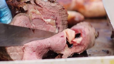 Juicy joint of meet being carved at a BBQ Stock Footage 80436742