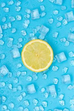 Juicy lemon on ice cubes background. Stock Photos