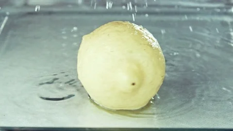 Juicy lemon. Lemon in water splashes. Video stock 80238925