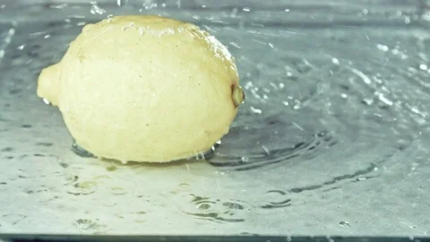 Juicy lemon. Lemon in water splashes. Stock Footage 80239363