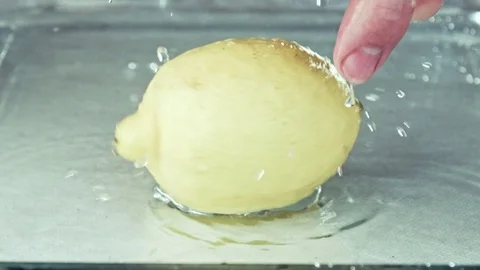 Juicy lemon. Lemon in water splashes. Stock Footage 80239609