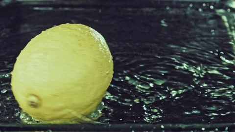 Juicy lemon. Lemon in water splashes. Stock Footage 80239921