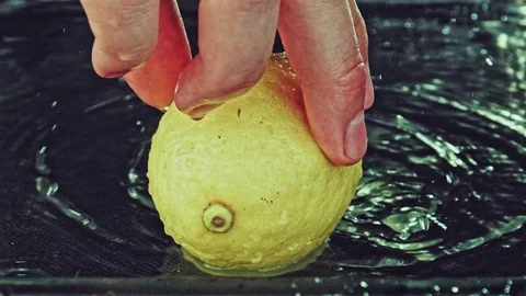 Juicy lemon. Lemon in water splashes. Stock Footage 80239976