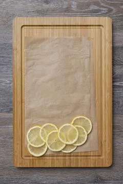 Juicy lemons cut into slices on a kitchen board Photos