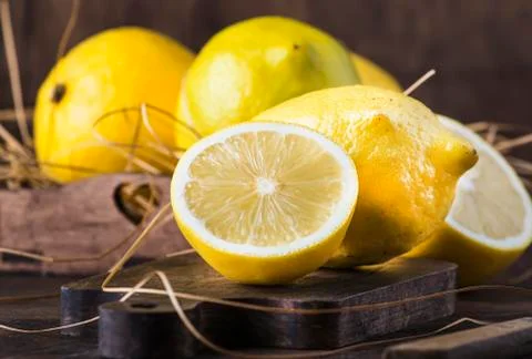 Juicy lemons on rustic kitchen table, copy space, selective focus Stock Photos