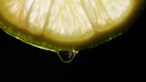 Juicy lime slice on black background. Citrus fruit close-up texture, healthy Stock Footage 196934421