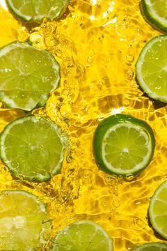 Juicy Lime Slices in Water from Above Stock Photos