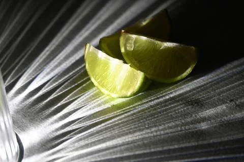 Juicy Lime Wedges with Dramatic Direct Light and Rays Shadow Effect Stock Photos