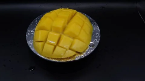 Juicy mango on a black background Stock Footage 329647996