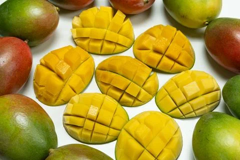 Juicy mango halves with cube cut pattern. Stock Photos