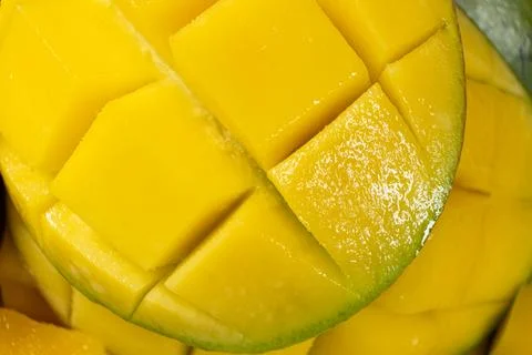 Juicy mango halves with cube cut pattern. Stock Photos