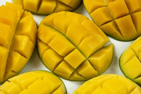 Juicy mango halves with cube cut pattern. Stock Photos