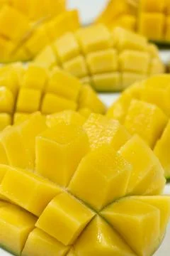 Juicy mango halves with cube cut pattern. Stock Photos