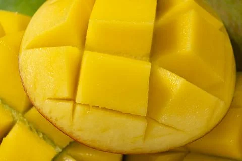Juicy mango halves with cube cut pattern. Stock Photos