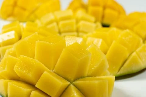 Juicy mango halves with cube cut pattern. Stock Photos