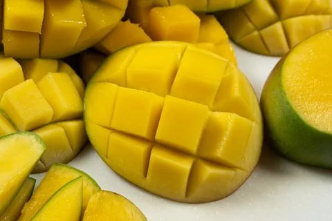 Juicy mango halves with cube cut pattern. Stock Photos