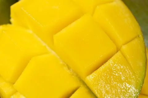 Juicy mango halves with cube cut pattern. Stock Photos