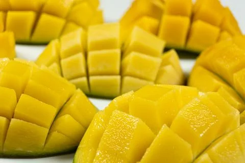 Juicy mango halves with cube cut pattern. Stock Photos