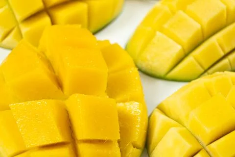 Juicy mango halves with cube cut pattern. Stock Photos