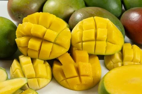 Juicy mango halves with cube cut pattern. Stock Photos