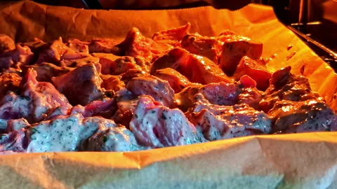 Juicy Marinated Meat Roasting in Oven With Creamy Herb Sauce on Baking Sheet Stock Footage 318199019