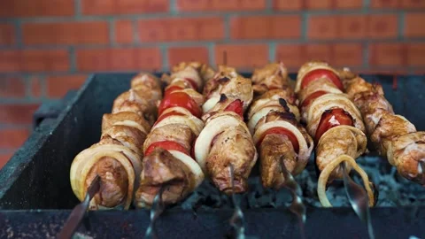 Juicy marinated pork and vegetable skewers grilling on BBQ Stock Footage 343385460