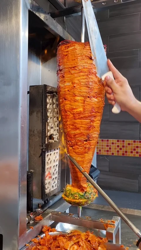 Juicy meat on a shepherd-style grill, with flames that cook it slowly. Stock Footage 343882529
