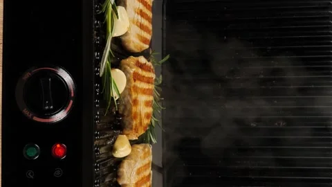 Juicy meat steak cooked on an electric grill, rosemary, black pepper, salt Stock Footage 247669350