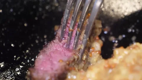 Juicy Medium-Rare Steak Cut with a Fork, Close-Up Stock-Footage 332817601