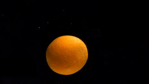 Juicy orange on black background Stock Footage 151863228