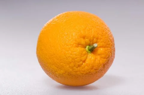 Juicy orange is on a gray background Stock Photos