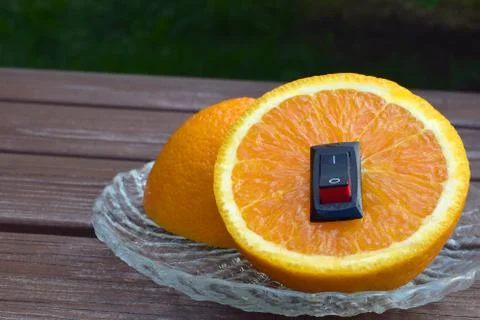 Juicy orange with inserted power switch Stock Photos