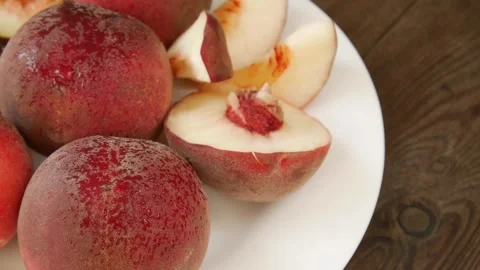 Juicy peaches on a plate. Stock Footage 328652199