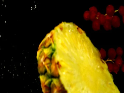 Juicy pineapple and red currant dropped into the water 1 Stock Footage