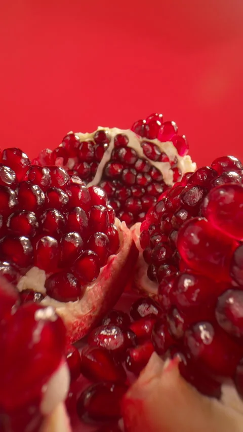 Juicy pomegranate on red background. Freshness, summer vibes, natural flavor Stock Footage 312376782