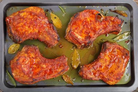 Juicy Pork Chops on baking sheet Stock Photos