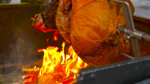 Juicy pork leg roasting on a spit over open fire 스톡 동영상 333394837