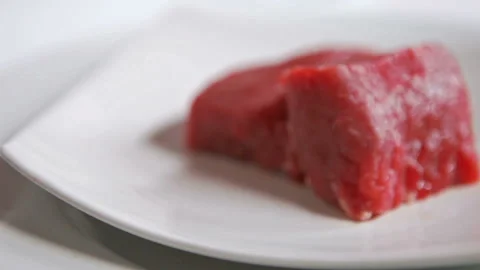 Juicy Raw Meat On Rotating White Plate, Close Up Stock Footage 130403189