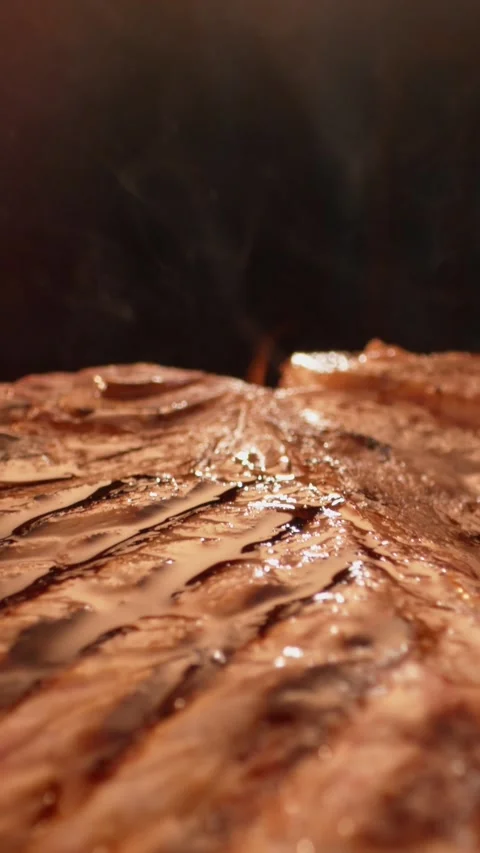 Juicy raw t bone steak searing on hot grill grate with rising smoke and bub.. Stock Footage 337440880