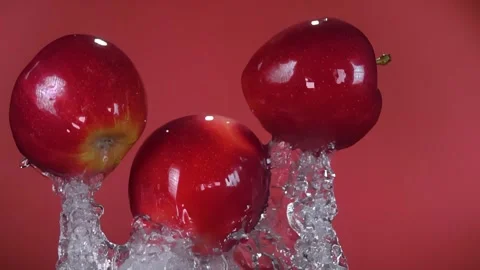 Juicy Red Apples Flying Up in a Splash of Water Stock Footage 314110840