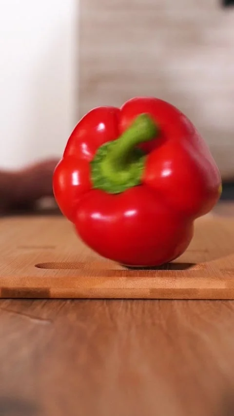 Juicy red bell pepper rotates on a wooden board. Slow motion. Stock Footage 306148589