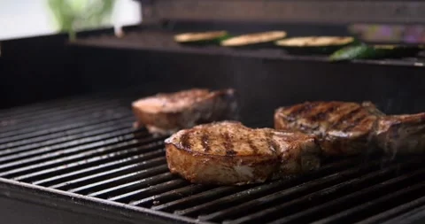 Juicy red meat placed on the grill steak on the flaming grill season Stock-Footage 336575916