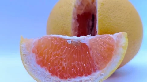 A juicy slice of grapefruit sways gently Stock-Footage 331746476