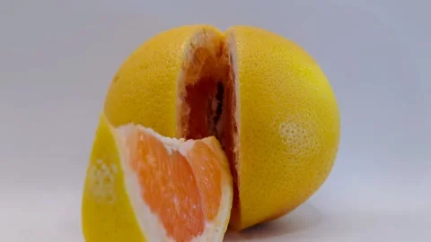 A juicy slice of grapefruit on a white background close-up 動画素材 331746532